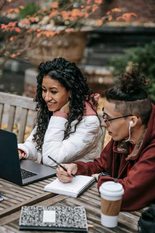 Members studying together with a laptop and notebook