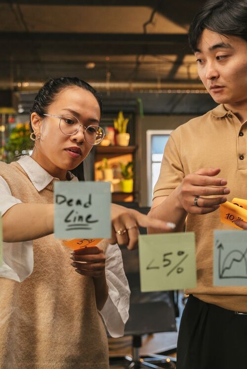 A research team reviewing ideas on sticky notes