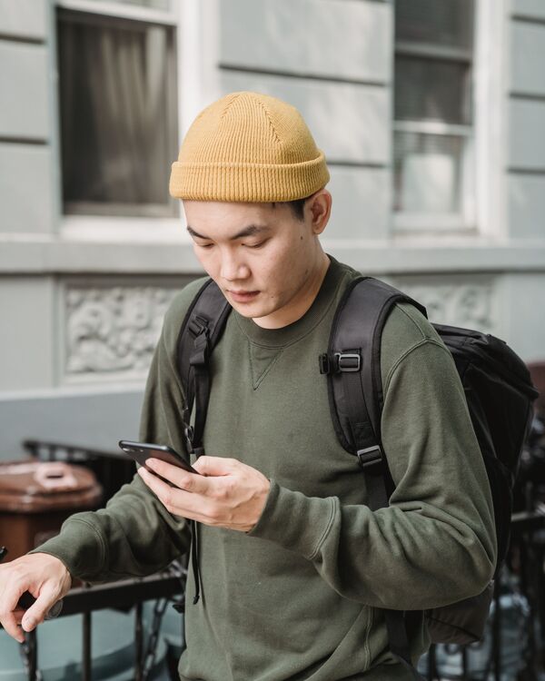 A member checking survey invitations on his phone