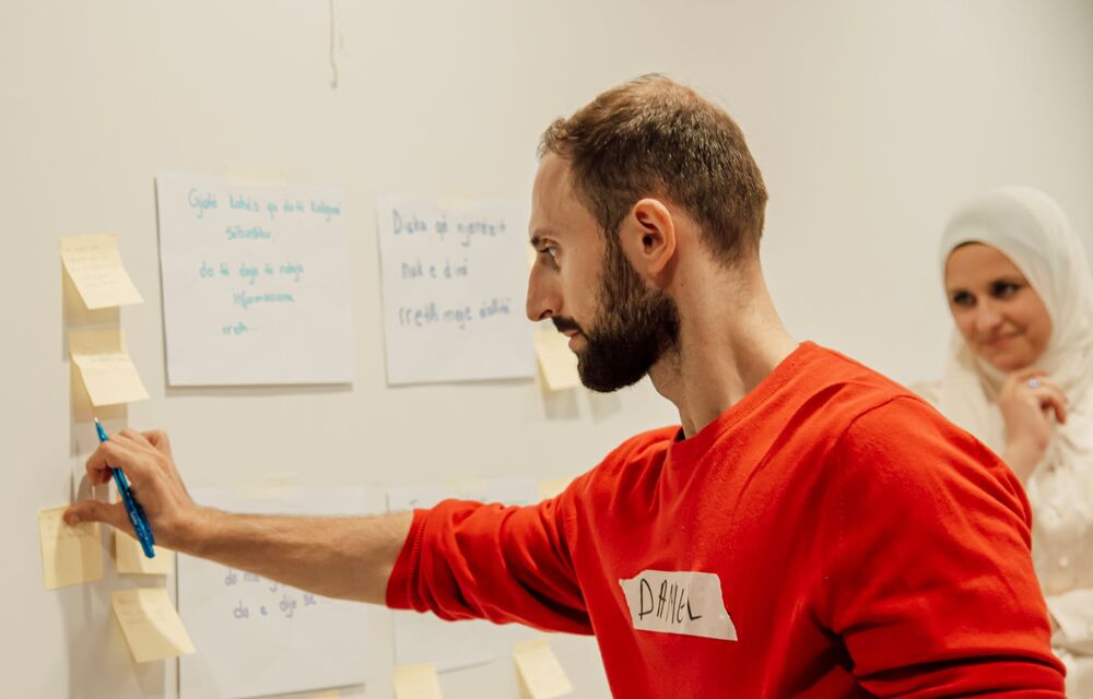 A professional planning a project with sticky notes